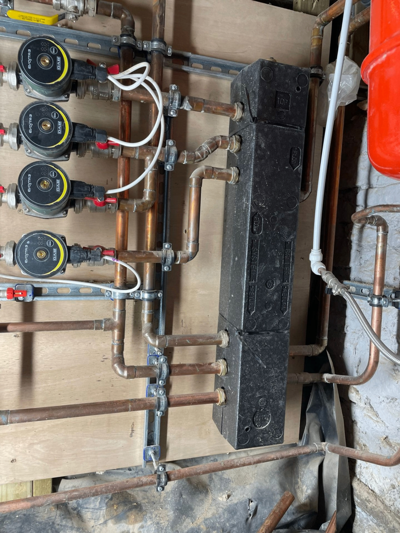 New floor-standing oil boiler installed alongside an external bunded green oil storage tank at a rural British home