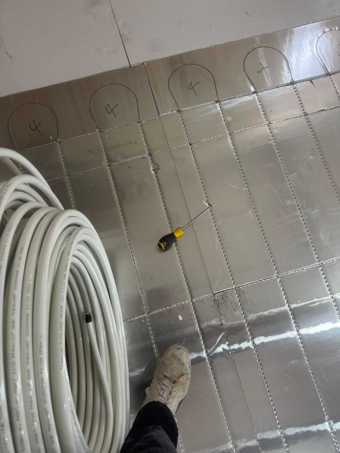 Neat copper pipework and isolation valves beneath a newly installed gas boiler