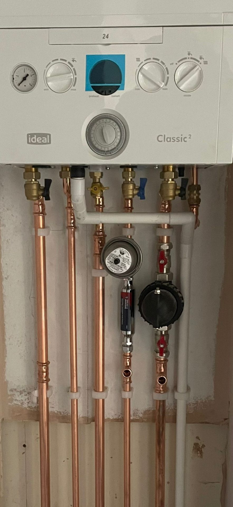 Oil boiler burner assembly with pressure gauge and diagnostic tools during a repair